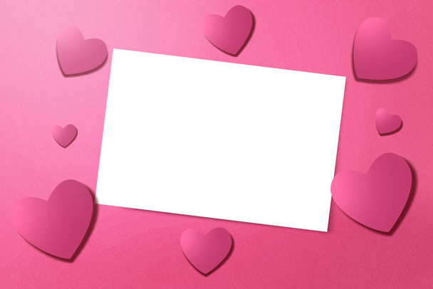 Empty white paper and heart with a colored background. Valentines Day. Empty space for copy space - Foto, imagen