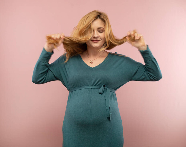 Portrait of a pregnant woman with flying hair - Photo, Image