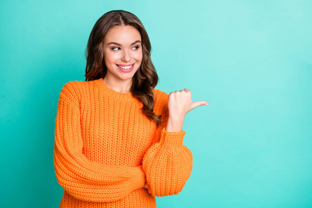 Photo of young attractive girl happy positive smile look point thumb empty space ad promo suggest isolated over teal color background - Valokuva, kuva