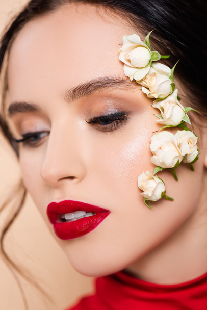 close up of young woman with red lips and flowers on face isolated on pink  - Foto, immagini
