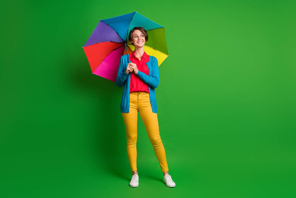 Full length body size photo of girl with bob hair keeping colorful umbrella looking blank space isolated on vibrant green color background - Fotografie, Obrázek