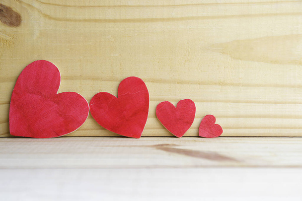 Background of four wooden hearts on an old rustic table - Photo, Image