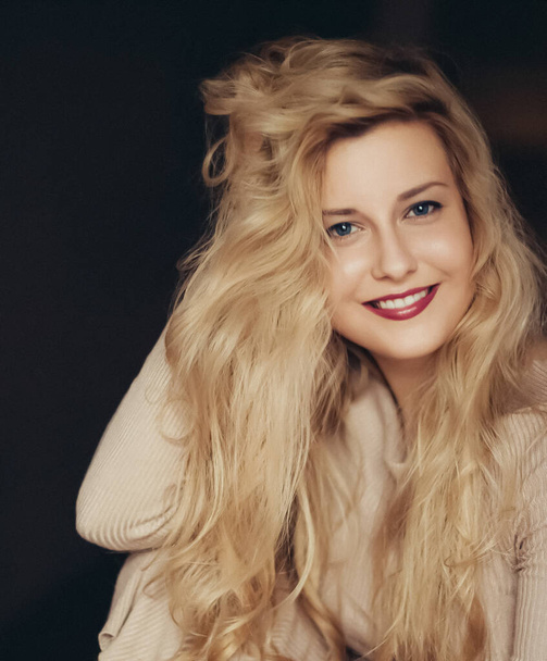 Natural hair care routine for blonde hair, woman with long wavy hairstyle, hairspray and styling product, beauty and 90s style look. Artistic film grain added - Photo, Image
