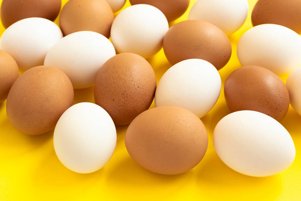 Brown chicken eggs on yellow background. Top view. Healthy food concept - Φωτογραφία, εικόνα