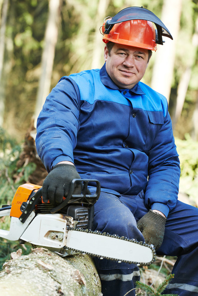 Lumberjack worker with chainsaw in the forest - Zdjęcie, obraz