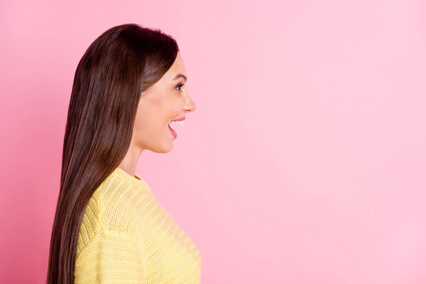 Photo of charming surprised young lady wear casual yellow outfit looking empty space isolated pastel pink color background - 写真・画像