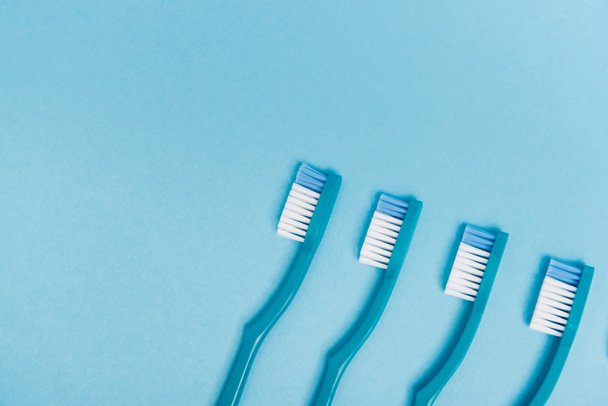 Top view of toothbrushes on blue background - Fotografie, Obrázek