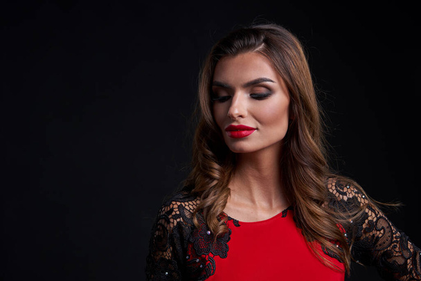 Closeup woman in red dress and red lips makeup looking at camera - Foto, Bild