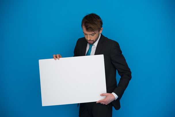 Businessman holding blank poster - Photo, Image