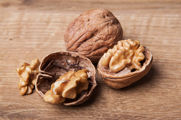 Walnut on wooden background. Healthy food and snack. - Photo, Image