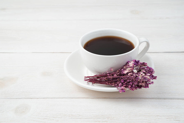 Delicate festive background with coffee and flowers on a white background. Side view. - Photo, Image
