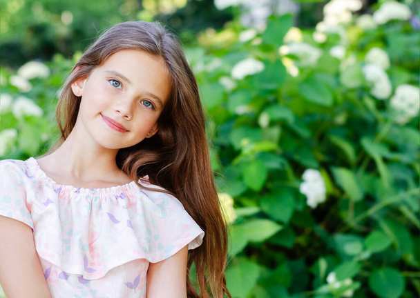 Portrait of adorable smiling little girl child in summer day. Happy preteen in the park outdoors  - Foto, immagini