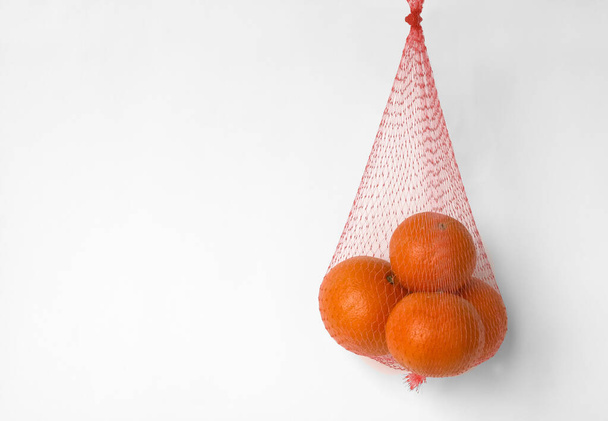 Tangerines in a grid on a white background - Fotoğraf, Görsel