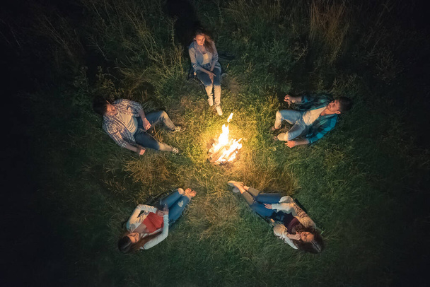 The five people rest near the bonfire. view from above, evening night time - Photo, Image