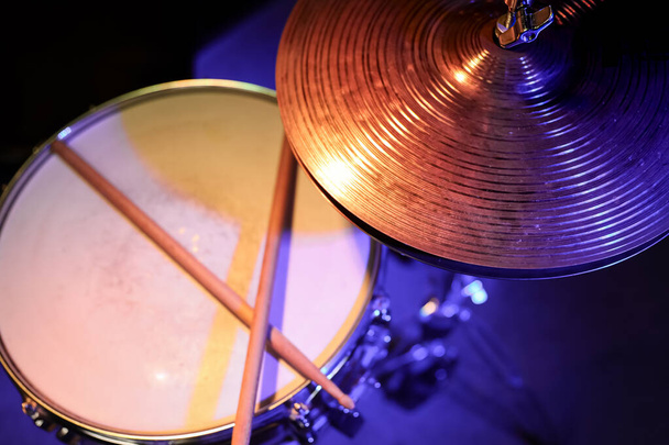 Part of a drum kit in the dark with beautiful lighting. Concert and performance concept. - Photo, Image