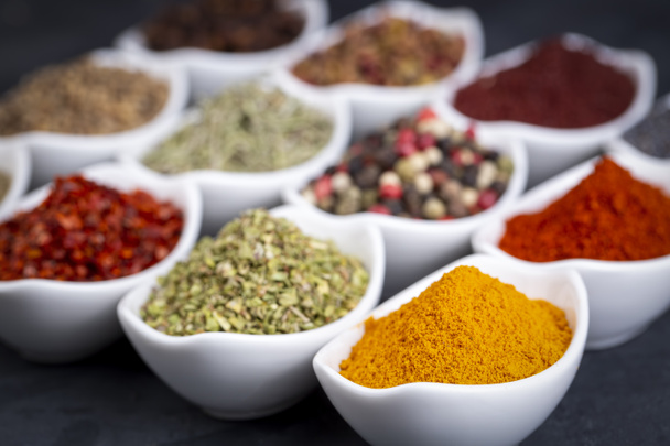 various spices in bowls on gray table - Fotoğraf, Görsel