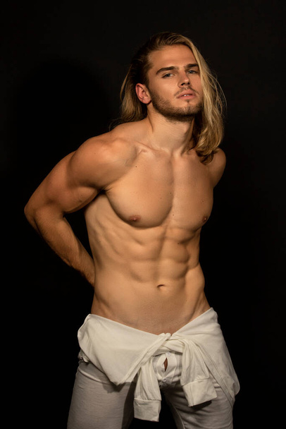 Sexy sport muscle strongface blond guy with long hair in white underwear on black isolated  font background - Фото, зображення