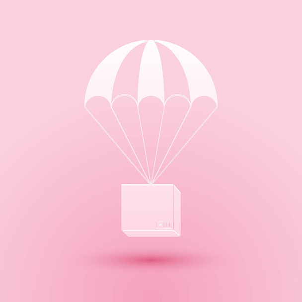 Paper cut Box flying on parachute icon isolated on pink background. Parcel with parachute for shipping. Delivery service, air shipping concept, bonus. Paper art style. Vector. - Vector, Image