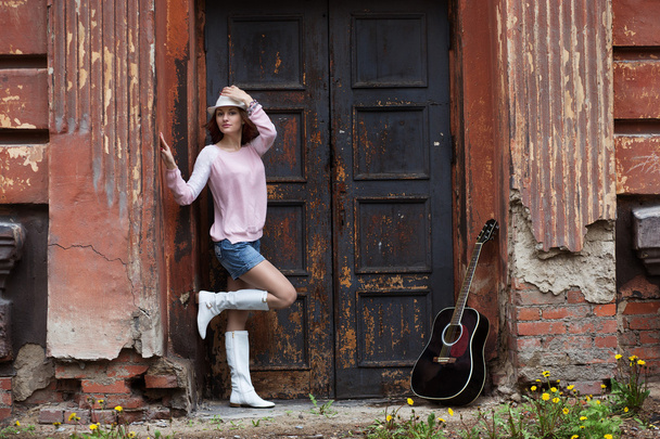 Girl with a guitar in an old building - Photo, image