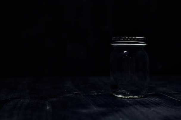 A jar on a black surface - Photo, Image
