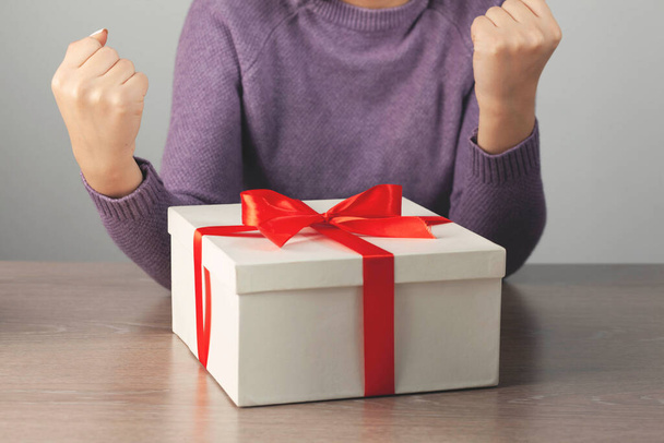 woman hand holding gift box on the desk - Photo, image