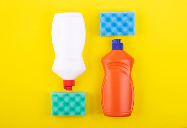 cleaning products display nolling on a yellow background, top view. the concept of cleaning and cleanliness - Fotografie, Obrázek