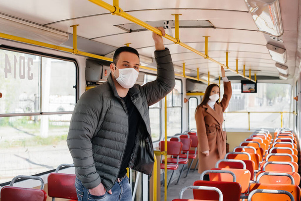 Passengers on public transport during the coronavirus pandemic keep their distance from each other. Protection and prevention covid 19 - Fotoğraf, Görsel