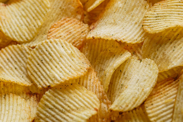 Potato chips or crisps .Potato chips texture background flat overhead view.concept of fast food and snacks. Food background. - Fotó, kép