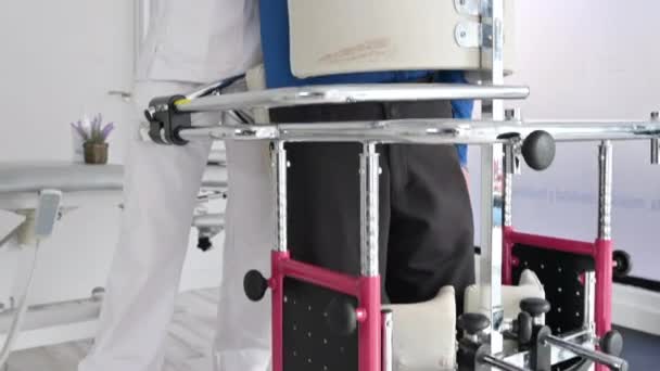 Physiotherapist assisting a patient with Amyotrophic Lateral Sclerosis. - Footage, Video