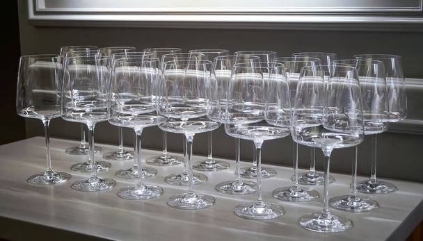 Empty clean wine, water, juice glasses in a kitchen of a restaurant or cafe. Catering buffet in restaurant room. Concept  preparing for celebration - Photo, Image