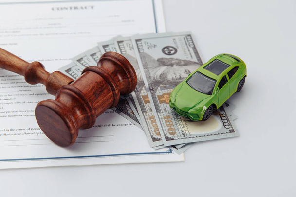Wooden hammer, toy car, money and contract, auction concept - Photo, Image