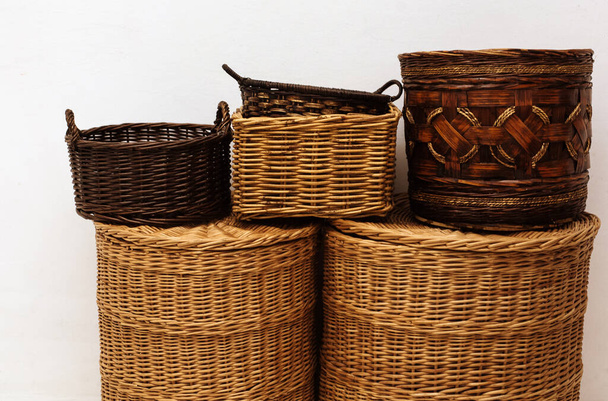 Close up handmade entwine straw wicker baskets with handle and cap for home storage, natural interior details  - 写真・画像