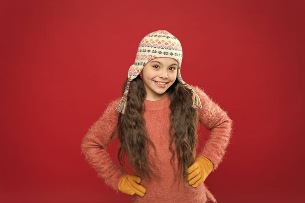 Protect your ears and hair from cold. being in playful mood. kid fashion. Warm knitting. happy little girl in earflap hat. seasonal health care. small child ready for winter. holiday activity outdoor - 写真・画像