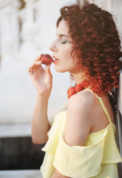 Glamour portrait of woman with a strawberry. - Fotoğraf, Görsel