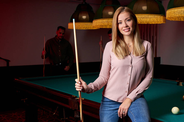 portrait of attractive lady came to play billiards or snooker with friends - Photo, image