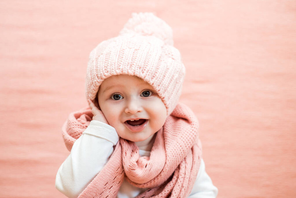 little girl in a knitted hat and gray scarf - Photo, Image