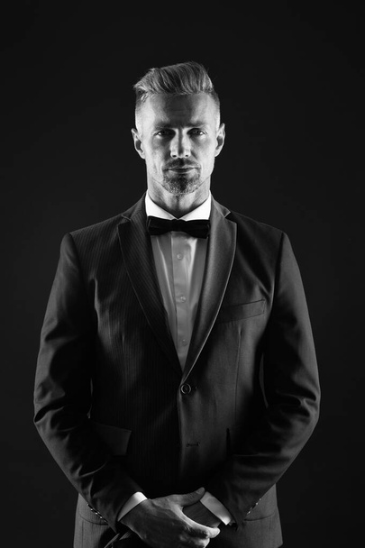 Handsome mature man tuxedo black background, wedding day concept - 写真・画像