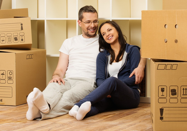 Giovane coppia positiva tra le scatole nella loro nuova casa
 - Foto, immagini