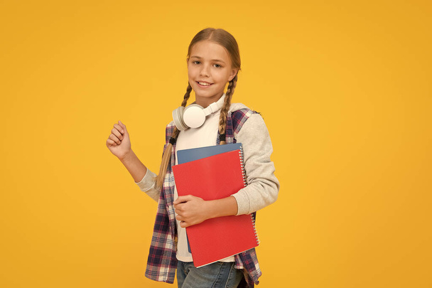 Study lessons for exam. find inspiration in music. Enjoying elearning. modern education concept. little girl in headphones with notepad. back to school. hipster child at school. childhood happiness - Φωτογραφία, εικόνα