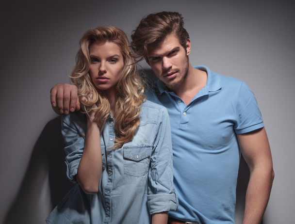 Portrait of a young fashion couple standing embraced - Photo, Image
