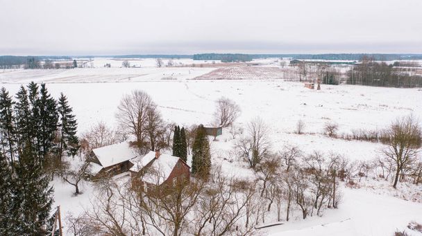 Akniste, Jekabpils, Latvia, Baltics.Beautiful panoramic aerial view photo from flying drone to Akniste city in winter.Beautiful winter view with snowy snow on small town fields and forests. (series) - Photo, Image