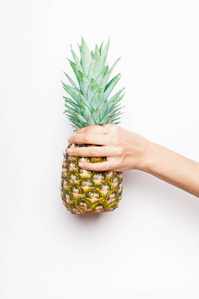 Ripe pineapple woman's in hand isolated on white background.  - Фото, зображення