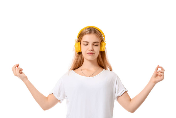 Beautiful young woman with headphones on white background - Foto, Imagen