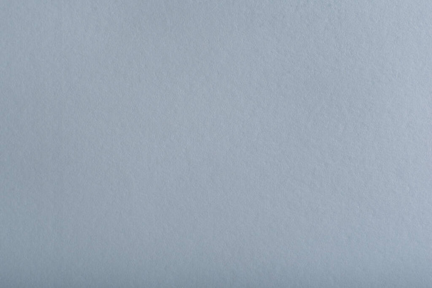 Sheet of gray paper. Clean gray background with smooth paper texture - Фото, изображение