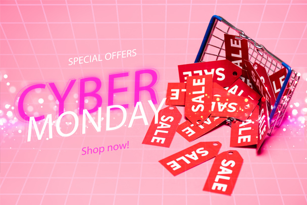 sale tags near shopping basket and special offers, cyber monday, shop now lettering on pink, black friday concept - Photo, Image
