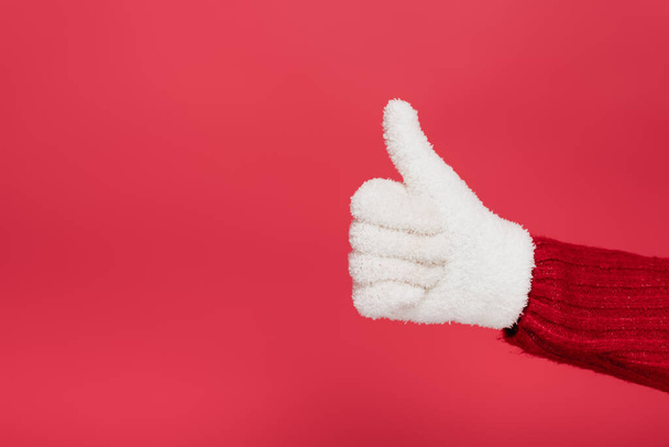 cropped view of woman in white glove showing thumb up isolated on red - Foto, imagen