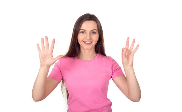 Молодая женщина в розовом свитере показывает 8 пальцев, как число восемь. - Фото, изображение