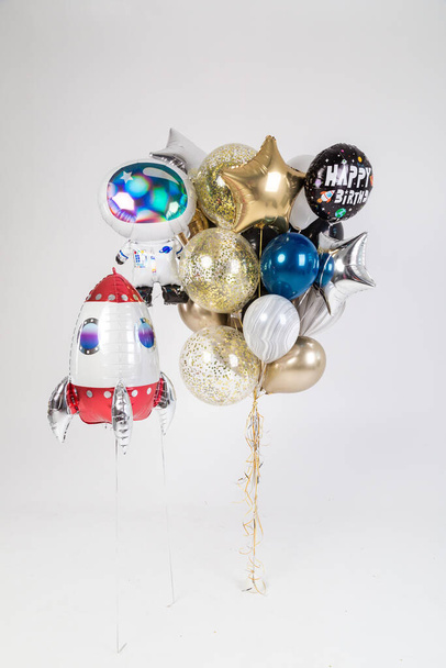 bunch of white, blue, gold balloons with the inscription Happy Birthday, as well as balloons in the form of a rocket and stars on a white background. Valentine's day gift - Fotó, kép