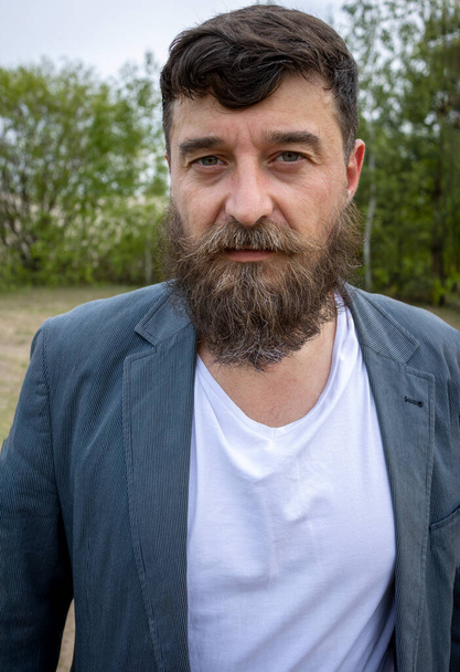 Closeup portrait bearded man on the nature background. - Zdjęcie, obraz