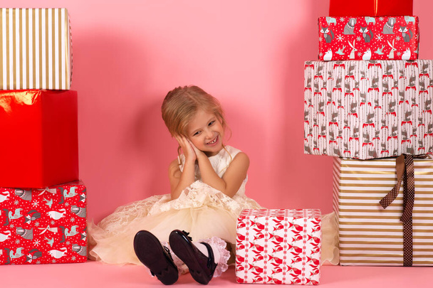 smiling girl with gift box sitting on the floor - 写真・画像